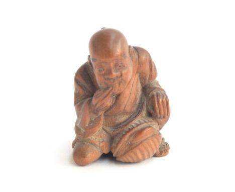 A Japanese boxwood netsuke of a kneeling man, 3.5cm highProvenance: the Peto Family, formerly of Chedington Court, Dorset