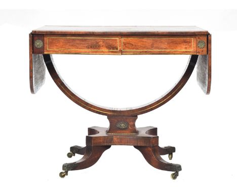 A Regency rosewood and brass inlaid sofa table, with two frieze drawers, on a semicircular stretcher support, quatrefoil base