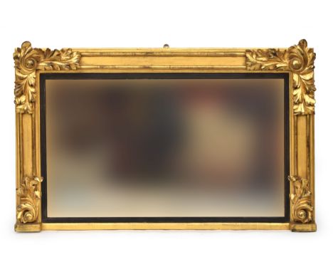 A Victorian carved giltwood overmantel mirror, applied carved acanthus leaves, the plate within a reeded ebonised slip, 118cm