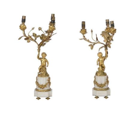 A pair of French Ormolu and white marble three-light candelabras, in Louis XVI style, late 19th century and later fitted for 