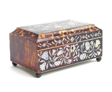 An early 19th century tortoiseshell sewing box, inlaid with floral mother of pearl decoration, opening to a silk lined interi