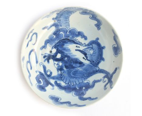 A Chinese blue and white dish decorated with a dragon amongst clouds, seal mark to base within double circle, 15.5cm diameter