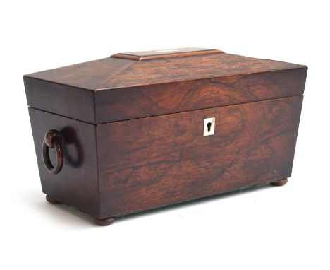 A Regency rosewood sarcophagus tea caddy, with mother of pearl inlay and twin turned loop handles, the interior with central 