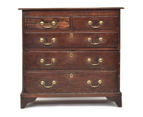 An early 18th century oak chest of two short over three graduating drawers, on bracket feet, cut in two halves, 97cm wide, 48