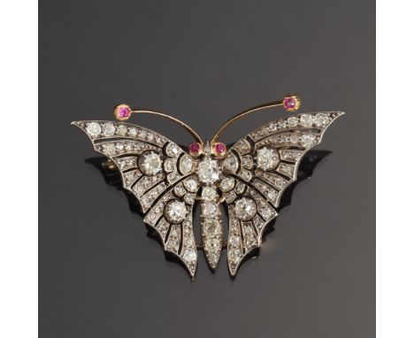 An exquisite Victorian diamond butterfly brooch, set in gold and silver with ruby eyes and antennae, each wing set with 28 ro