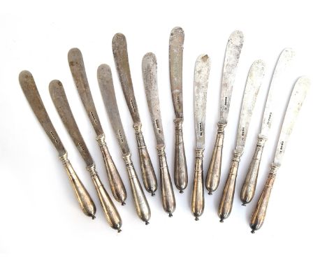 A set of twelve Victorian silver butter knives by Harrison Brothers & Howson, Sheffield 1883, the handles engraved with a win