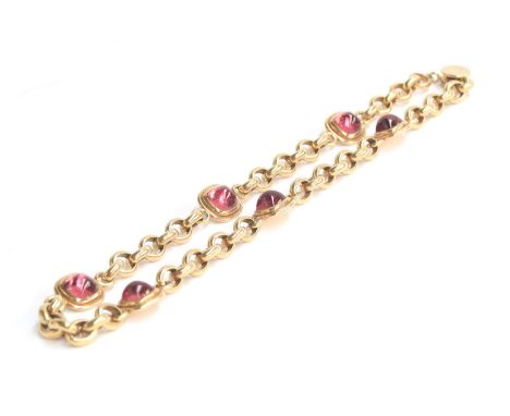 A Cassandra Goad 9ct gold necklace, the chain interspersed with six gold mounted pink tourmaline sugarloaf cabochons, each ca