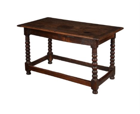 An early 18th century oak side table, the rectangular top above bobbin-turned legs, 131cm wide, 71cm deep, 75cm high 