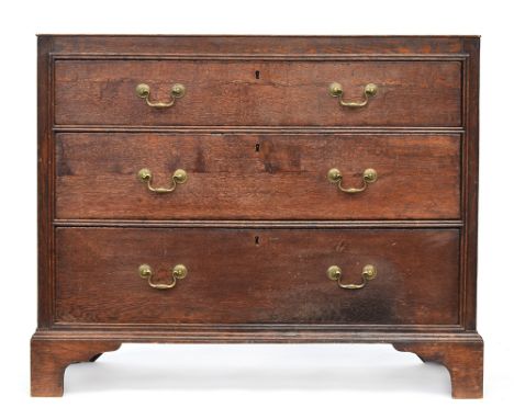 An 18th century oak chest of three graduating drawers, the drawers surrounded by carcass mounted double bead moulding, raised
