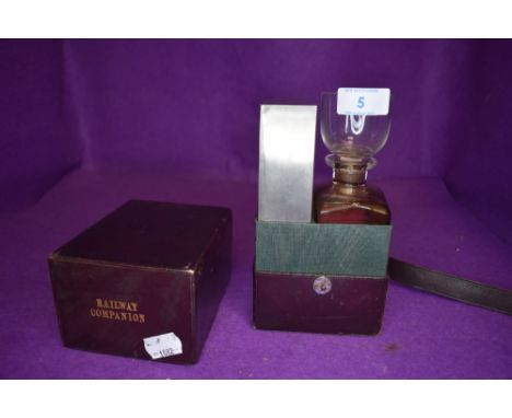 A vintage Railway travel companion set comprising of decanter and glass set with metal biscuit box and leather container