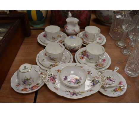 A collection of Crown Derby china, having floral pattern including cups and saucers, jug, strainer, sugar basin and more.