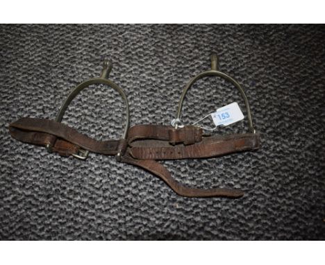 A pair of vintage leather and metal spurs.