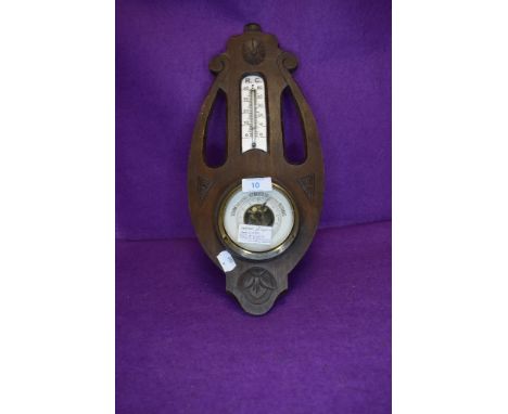 An arts and crafts styled German barometer having mercury and glass thermometer