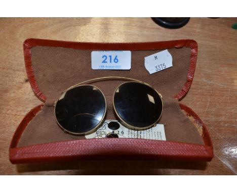 A set of vintage clip on polarised lenses with original tags attached.