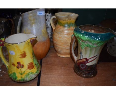 Four vintage water jugs including two art deco design by Beswick, Price bros and Burleigh ware Blacksmith