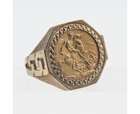 A George V 1911 gold sovereign set in a heavy 9ct ring, overall weight 16.8g.