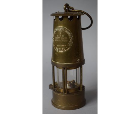 A Brass Miners Safety Lamp by the Protector Lamp and Lighting Company 