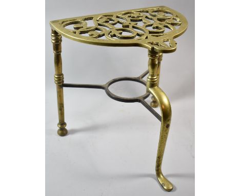 A 19th Century Brass and Iron Tripod Footman with Pierced Top and Scrolled Front Support, 32.5cm wide 