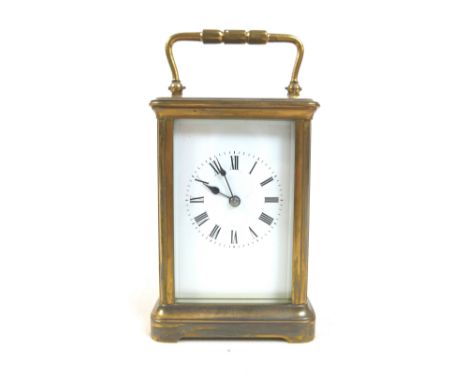 A late Victorian brass carriage clock striking on a gong with leather outer case, 9cm by 7cm ,16 cm tall with handle upGlass 