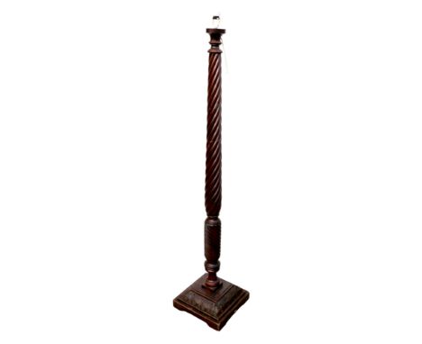 A Georgian mahogany spiral carved standard lamp, with a square carved stepped base, made from a bed post, 33 by 33 by 160cm h