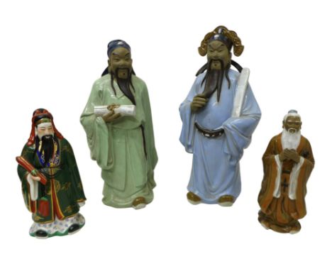 A group of four modern Chinese pottery figures, modelled as a man holding a scroll in pale blue robe, 51cm high, one holding 