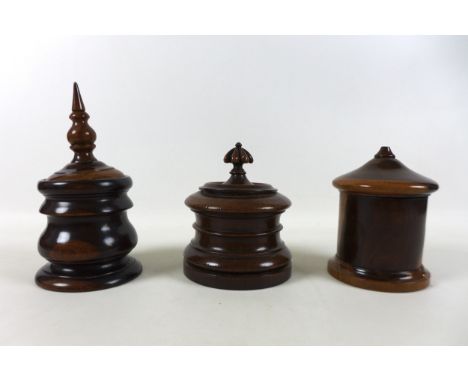 Three exotic wood lidded jars including a Lignum Vitae string jar, tea caddy and tobacco jar 24cm tall 13cm diameter.  Condit