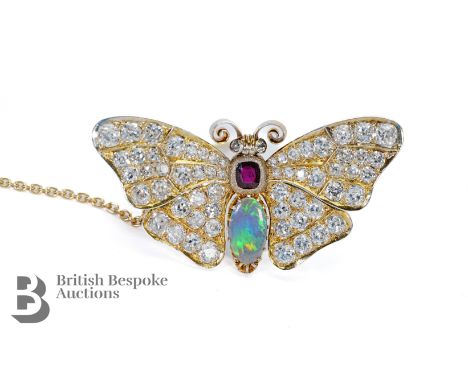 An 20th Century 18ct yellow gold&nbsp; diamond, opal and garnet butterfly brooch. The wings and eyes set with sixty-two circu