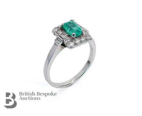 Vintage 18ct white gold emerald and diamond ring. The ring set with a South African emerald approx 6.5 x 4.2 mm, surrounded b