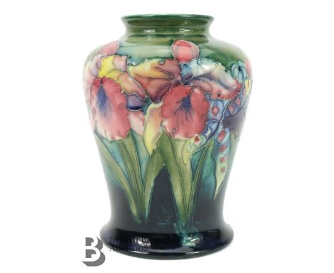 William Moorcroft vase, decorated with pink Iris on green ground, factory marks to base, approx 14 cms. (*cr)Condition Report