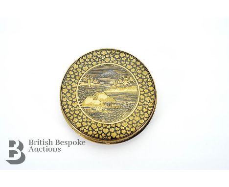 Early 20th century Japanese Shakudo compact, depicting a distant view of Mount Fuji, character marks to verso, approx 60 mm d