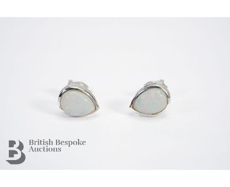 Pair of silver and opal stud earrings.