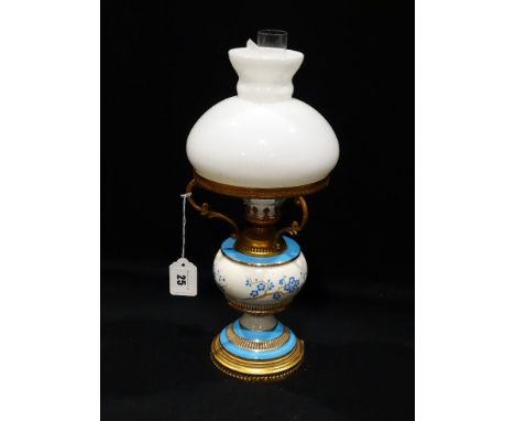 A Circular Based Gilt Metal & Pottery Oil Lamp With Milk Glass Shade