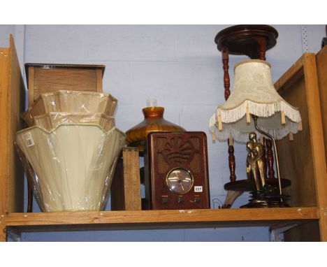 A shelf of assorted, radio sets, lamps etc.