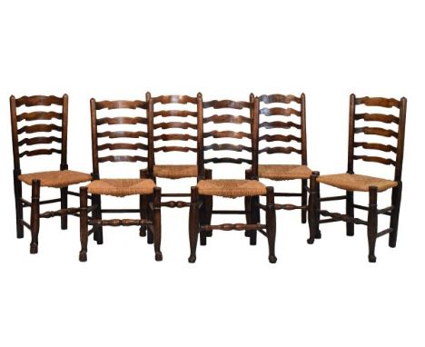 Matched set of six 19th Century ash and oak ladder back dining chairs, each having a rush seat and standing on tapered pad su