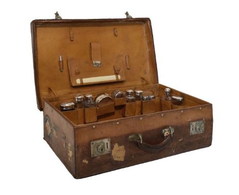 Late 19th/early 20th Century leather suitcase, opening to reveal a fitted interior with eleven glass requisites, each having 