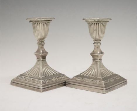 Pair of Victorian silver Adam style desk or dressing table candlesticks, each having fluted decoration and standing on a squa
