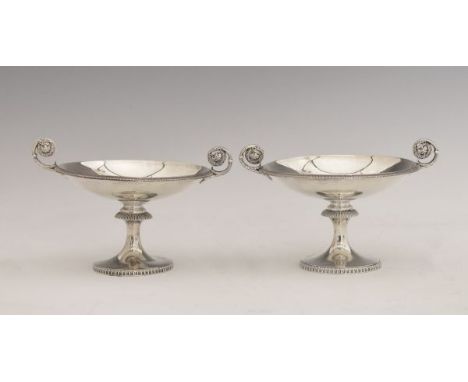 Pair of George V silver sweetmeat stands, each having lion mask scroll handles and standing on a circular foot, makers James 