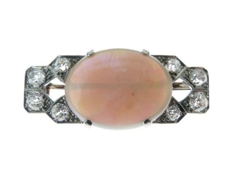 Opal and diamond plaque brooch, the oval shallow cabochon approximately 21mm x 16.5mm x 6mm deep, the frame of eight old bril