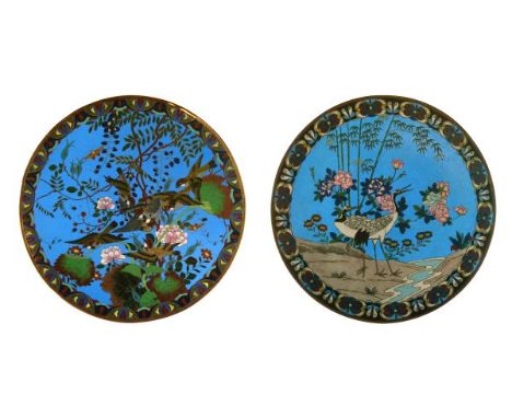 Two Japanese cloisonné dishes, each Meiji period and decorated with birds amongst foliage on a blue ground, 30cm and 30.5cm d