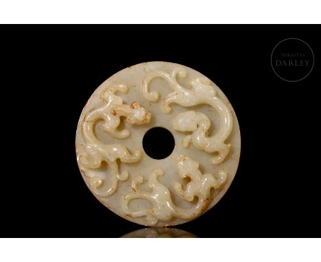 Carved white jade, faintly toned with a milky finish, covered with fine reddish and golden flecks. It is circular in shape, w