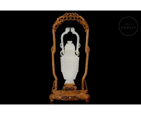 Jade of a soft white hue carved in the form of a vase. It has a balustraded profile, starting from a narrow rectangular base,