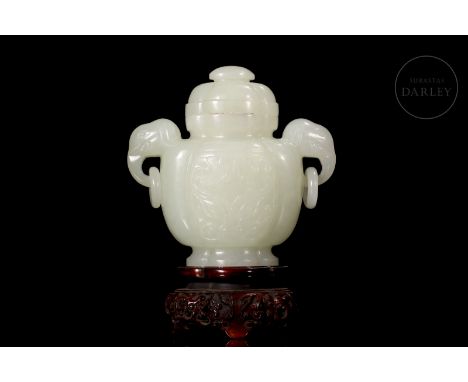 Elegantly carved white jade. It has a broad lobed base, on which is a rounded body flanked by two elephant's head-shaped hand