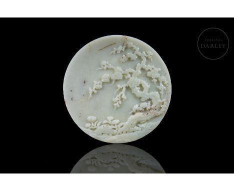 White jade with a subtle greenish hue and dotted with fine reddish flecks. It is in the shape of a disc, decorated with an el
