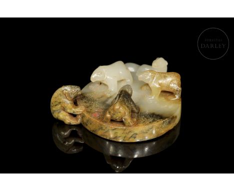 White jade with flecks of brown and reddish tones, carved in the form of a disc with a central hole.  The lower part is decor