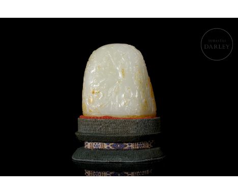 Carved white jade with reddish and amber flecks. It has an organic shape, with a wide elliptical base on which the body rises