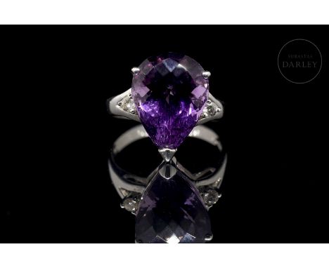 18k white gold setting with a faceted pear-cut amethyst, total weight 8.71 ct. It is set ‘in the air’ with two angular claws 
