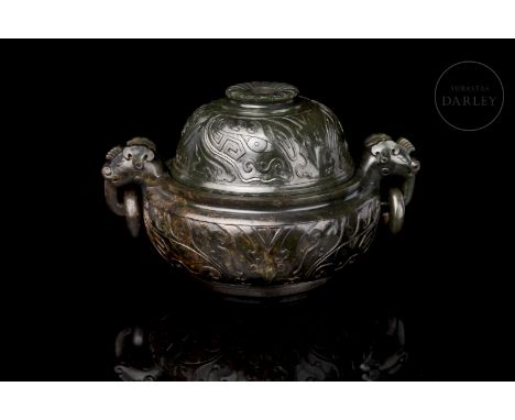 Jade of a dark greenish hue, with reddish tabby patches. It has a circular base on which is placed a deep body with a curved 