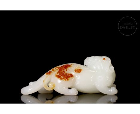 A pristine white jade carved in the shape of a mythical beast in great detail. It crouches in a crouching position, its body 