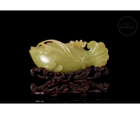 Yellow jade with subtle golden flecks. It is carved in the form of a beautiful fish, with a scaled body, detailed fins in rel
