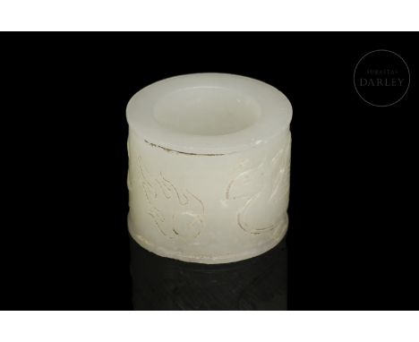 Archer's ring (??) of carved white jade. Adorned by a continuous scene, framed by two thin lines, of a beautiful phoenix with